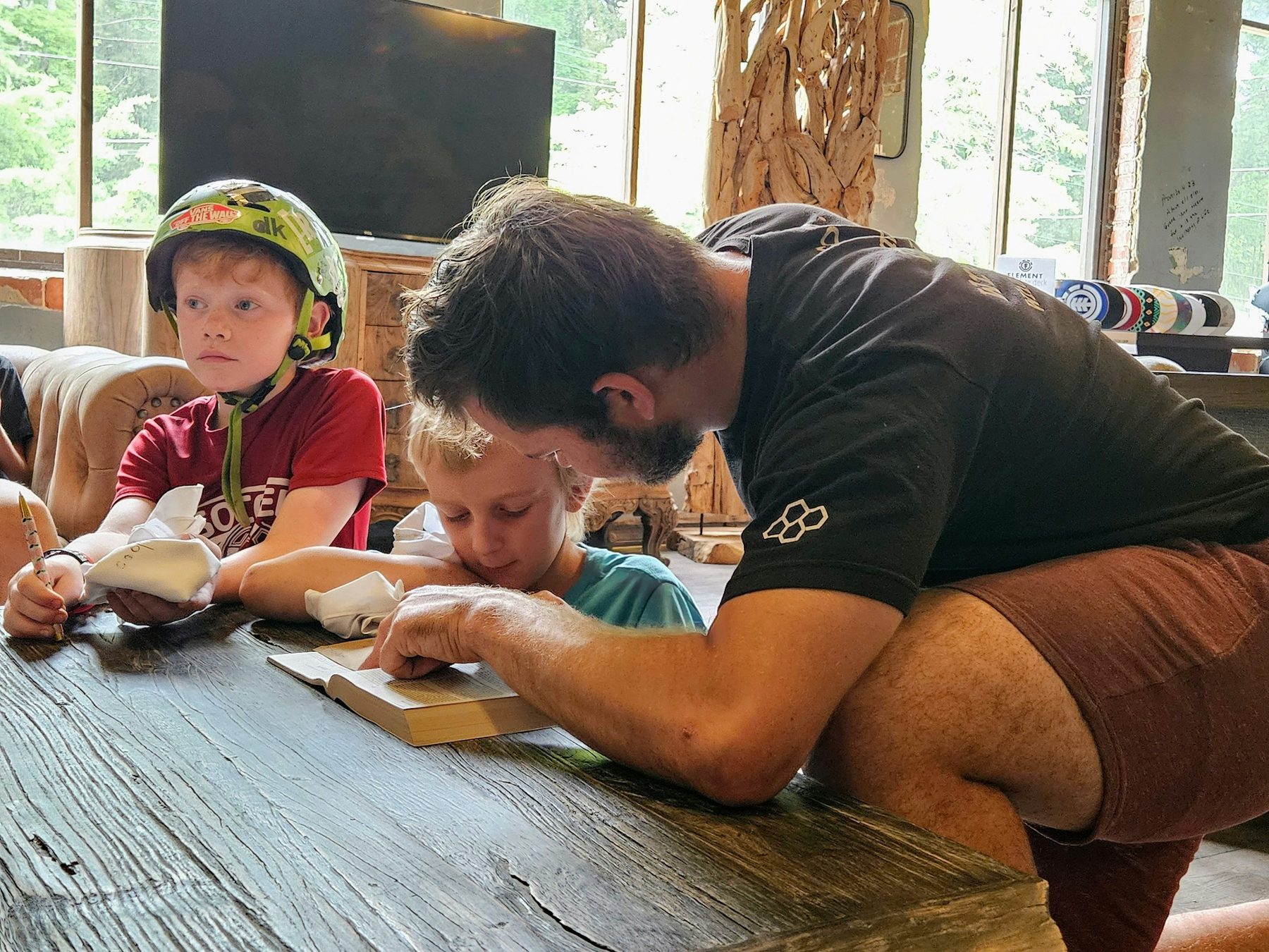 Mentor and kids reading the Bible together.
